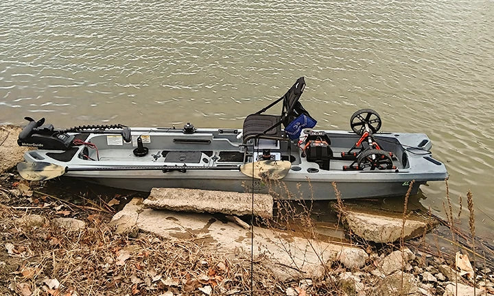 A rugged fishing boat with a trolling motor sits at the water's edge, ready for its LiTime battery