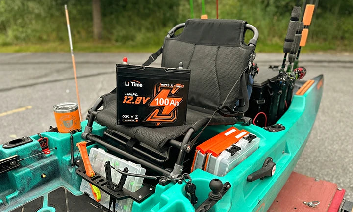 A LiTime 100Ah group 24 battery sits perfectly in the cargo area of a modern fishing kayak