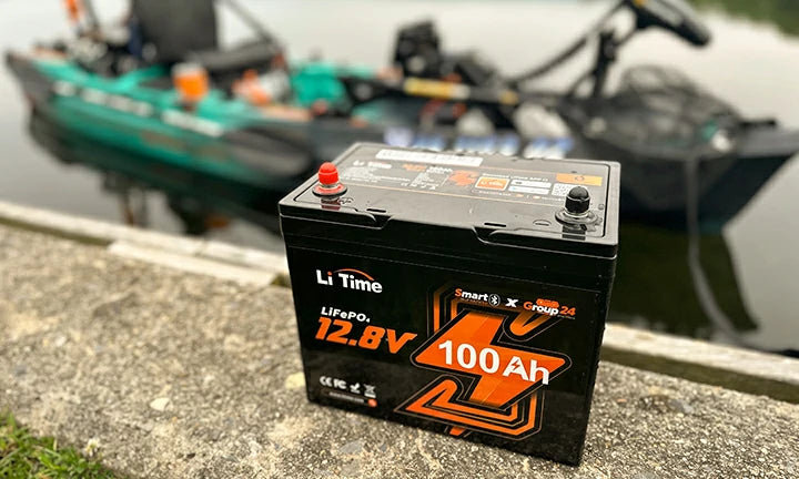 A LiTime 100Ah battery sits perfectly in the cargo area of a modern fishing kayak