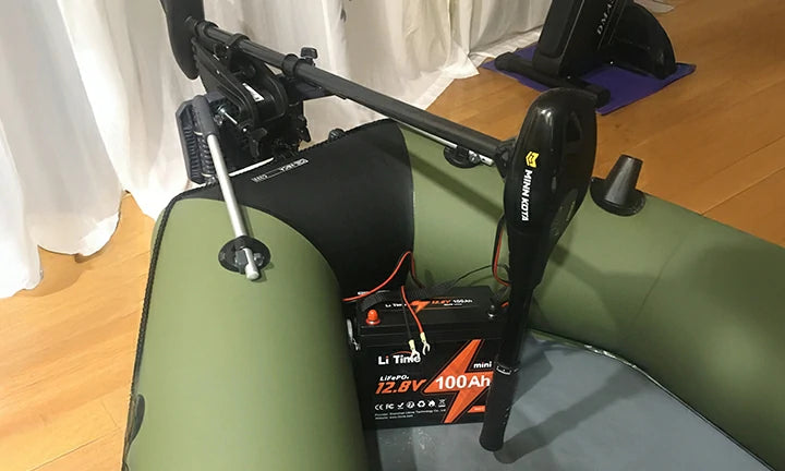 A LiTime 100Ah mini battery paired with a Minn Kota trolling motor in an inflatable boat