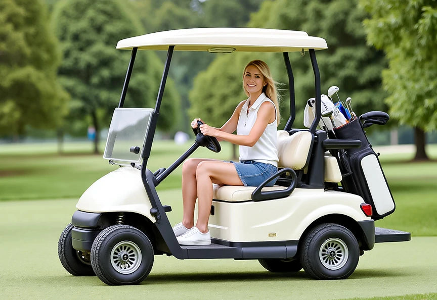 A woman is smiling and sitting in a golf cart.