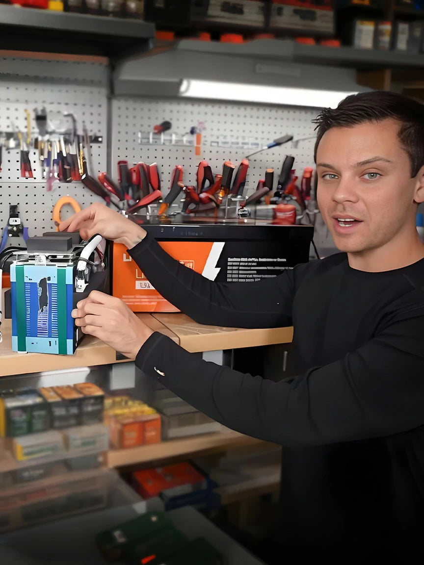 A man in a workshop setting, filming a technical review or demonstration of a LiTime battery