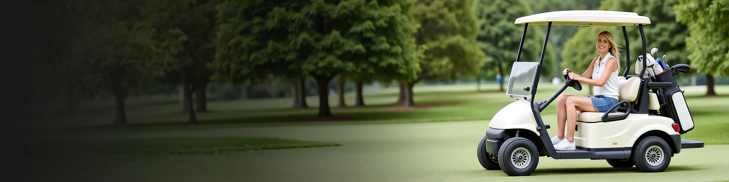 A woman is smiling and sitting in a golf cart.