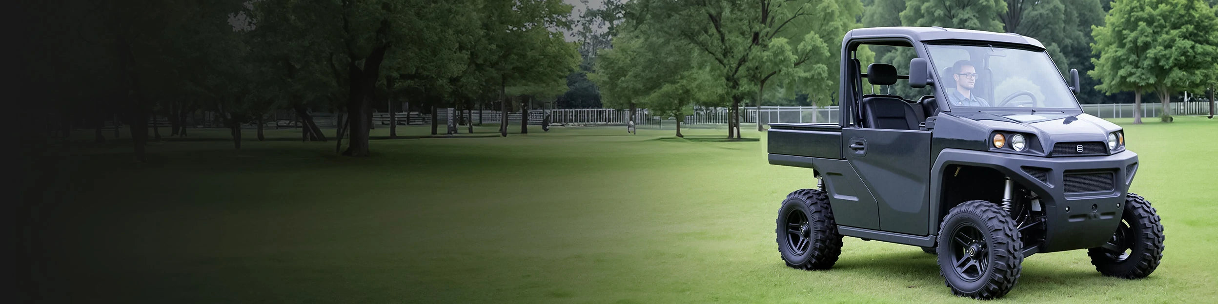 A man driving a black utility golf cart on a grassy field, highlighting features for golf cart lithium batteries.