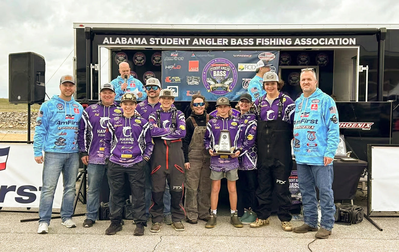 The Hawks Fishing team and their coaches pose with a large trophy at an Alabama Student Angler Bass Fishing event